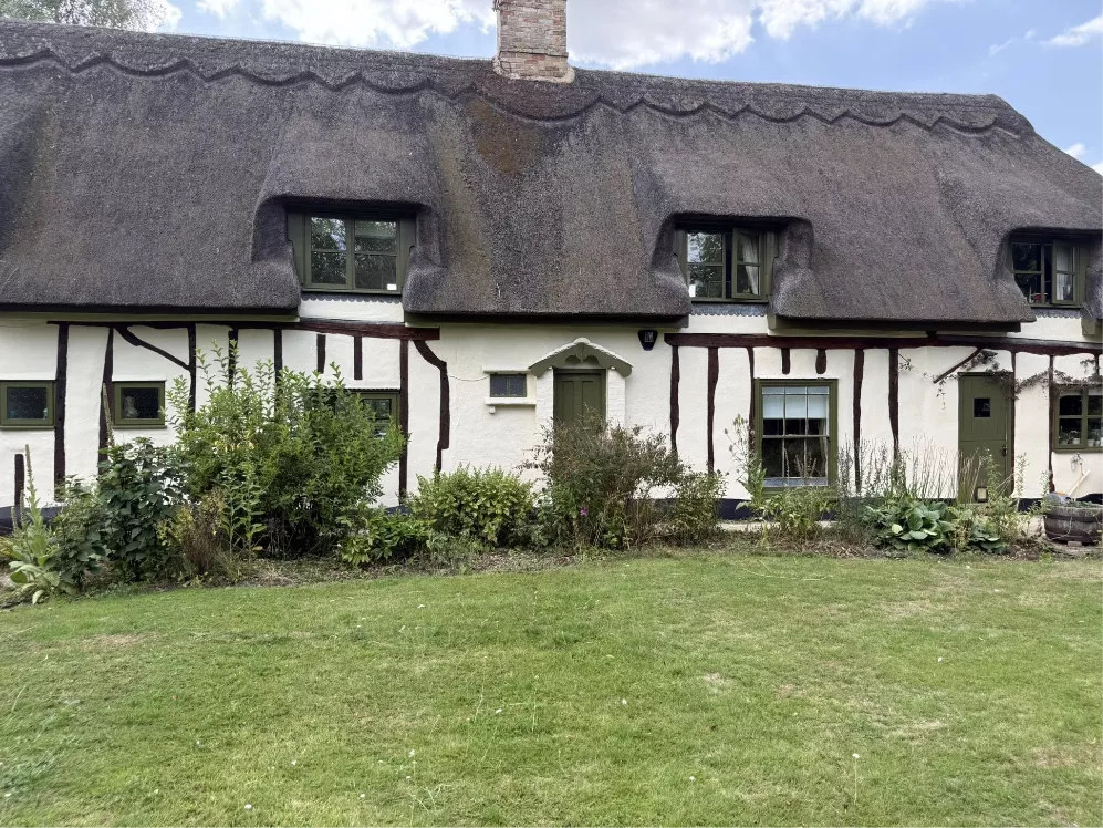 Exterior painting on thatched cottage